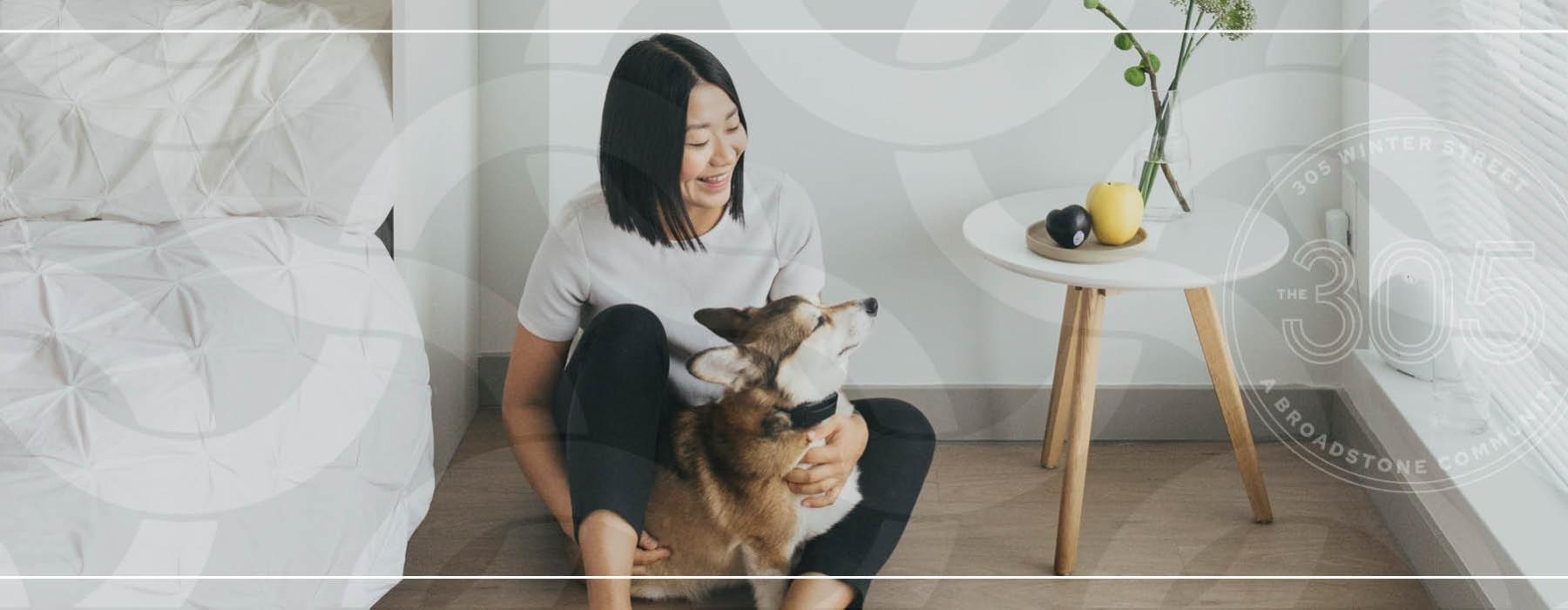 a person sitting on a couch with a dog